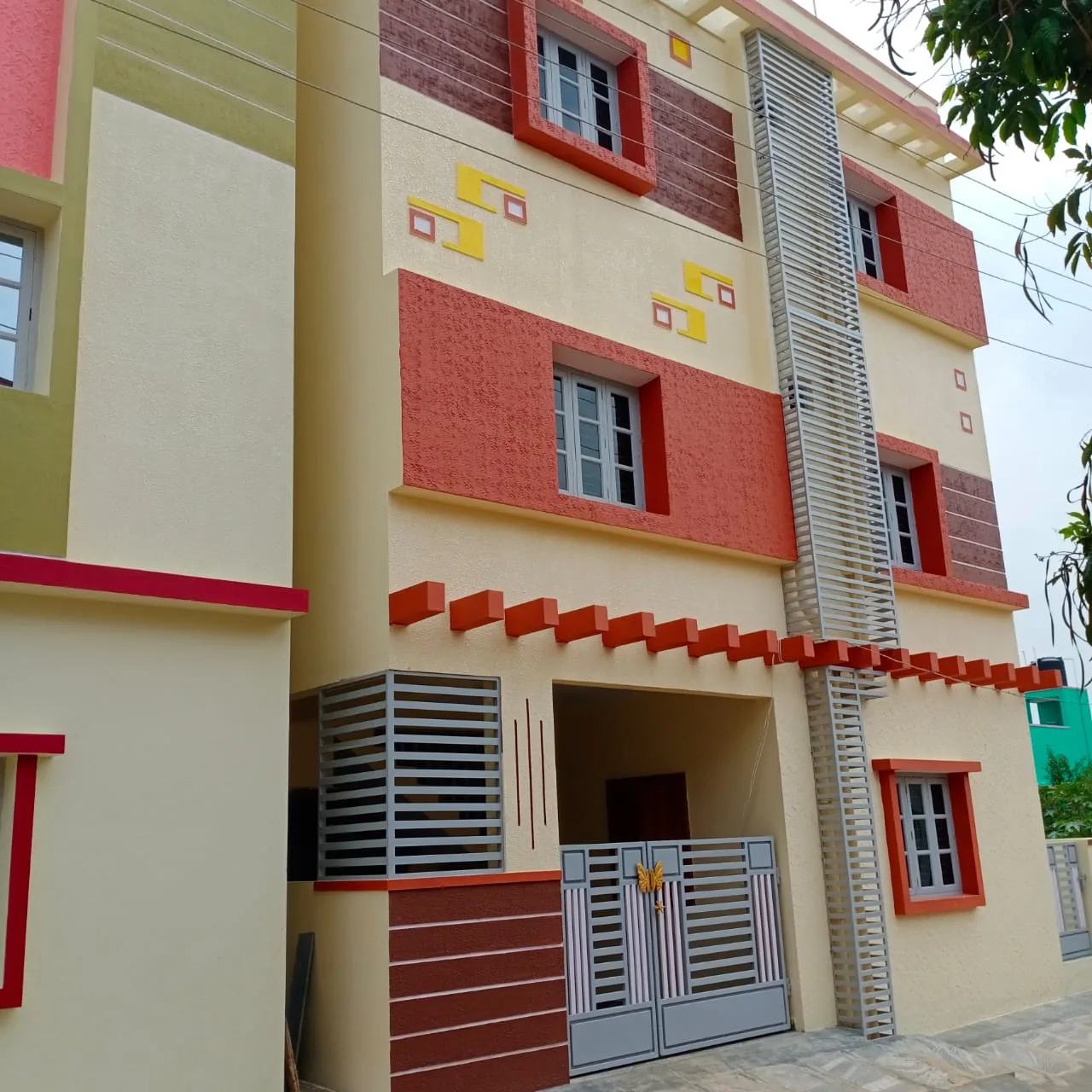 A finished multi-storey building exterior with decorative painted trim